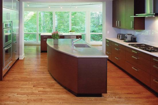 A Sink with a View is a hard-working kitchen. The plan offers several views from the sink side of a stainless-topped island, an element that anchors the room.