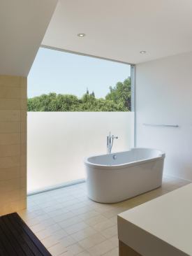 The glass window in the master bath offers privacy from the street but still permits light.

