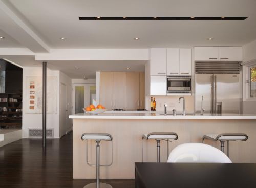 The architects pulled the kitchen to a more prominent location in the floor plan, which fits seamlessly in the new open plan.

