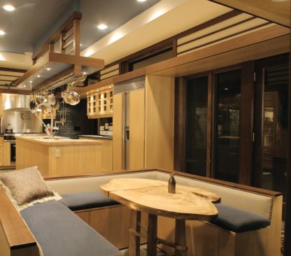 The corner kitchen opens on its narrow end to a cozy dining nook. The wider side presents a public face to the larger living spaces.