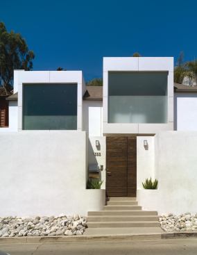 The reinterpreted bay windows gesture to the street, bringing light to the master suite and hiding the tile roof lurking in the back. 

