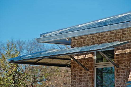 Custom-fabricated sunshades mimic the standing-seam metal roof, providing shading as well as an architectural element.