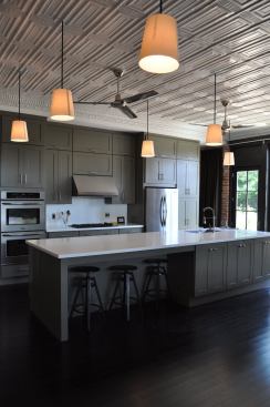 Hanging from the restored ceiling are off-the-shelf floorlamps that were re-rigged as pendants. 