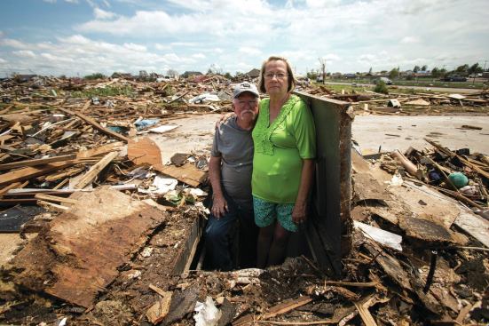 John and Cheryl Molsbee stand in the storm shelter that saved their lives in May.