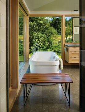 A sapele and blackened steel bench designed by Finne provides a convenient place for towels and clothing.

