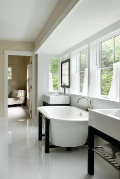 A generous bay window makes using the bath seem like more of an outdoor experience.