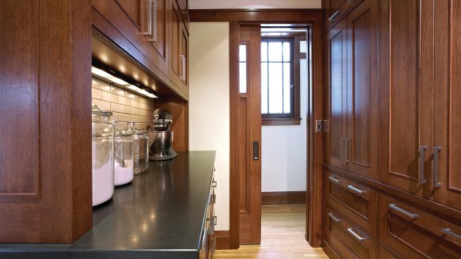 Walk-in pantry storage frees the outside walls for windows.