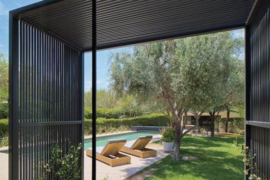 Two steel boxes frame the windows and provide shade to the theater room.