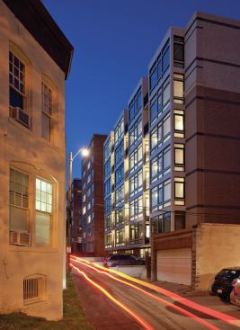 The front of the condos are traditional brick facades. At the back is a modern seven-story section that contrasts with the facade.