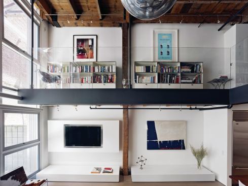 The minimalist design strategy maximized the wall space available for the homeowner's art displays.