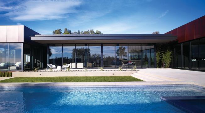 The single-story C-shaped box wraps a south-facing courtyard and swimming pool.