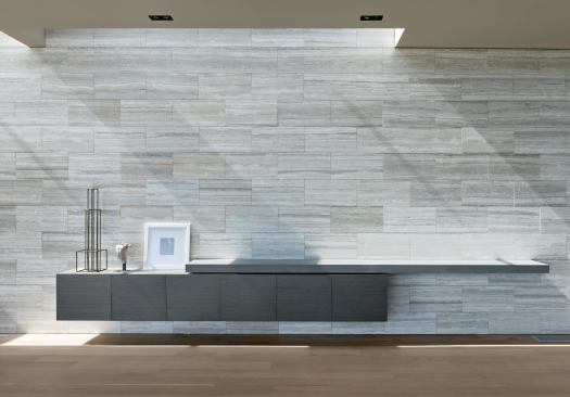 The silver travertine entry wall slips through the front door, continuing into the living area.