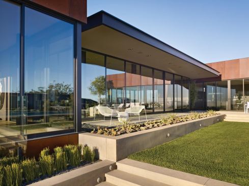 The master suite (left foreground) protrudes slightly over the down slope, acting as a deck when the sliding glass panels are opened.