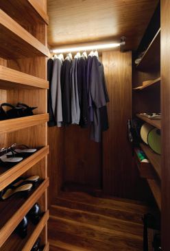 The new dressing room is lined with FSC-certified walnut and ample shelf space.