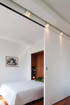 A large sliding door allows the owner to separate the sleeping area from the main living space.