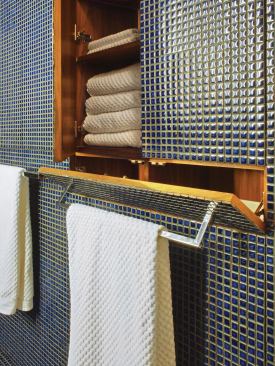 Clever built-ins and features such as a hidden hamper help the space live large.