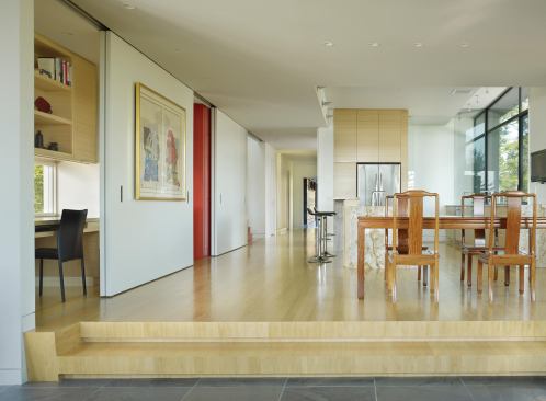 Sliding partitions reveal or conceal the stair.