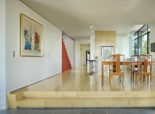 The stair provides sculptural interest and a jolt of color to an otherwise quiet interior. 