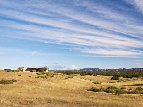 The home's reliance on thermal mass, night cooling, passive solar orientation, shading, and natural ventilation enabled the clients to forgo an active cooling system.