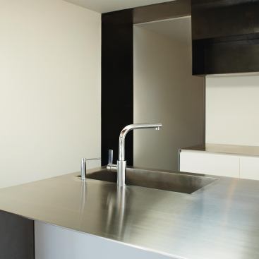 Blackened steel plate wraps the doorway to the house’s back hall.