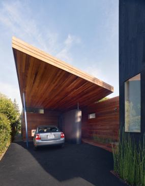A new carport roof incorporates bold geometry and richly textured wood.