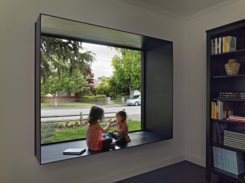Terry & Terry also renovated the existing house. Here, they punctuated the presence of a street-facing picture window with a modern steel frame.