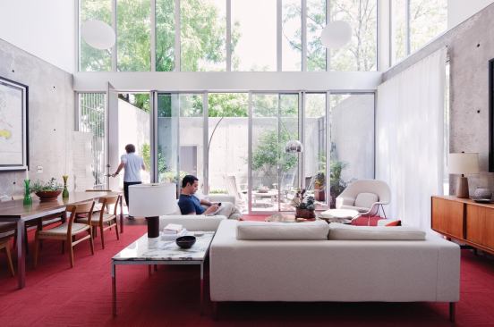 A wall of glass doors connects the main living space and the garden.