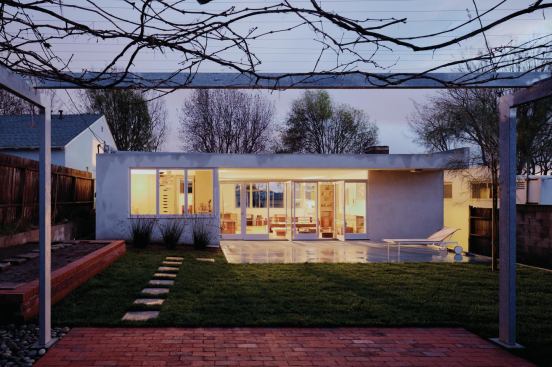 In the backyard, an existing 70-year-old grapevine grows over a new galvanized steel trellis, inspired by the sleeping porches of Schindler’s Kings Road house. 


