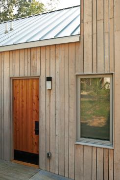 Exterior materials include a metal roof, custom cedar door, and Atlantic white cedar siding.
