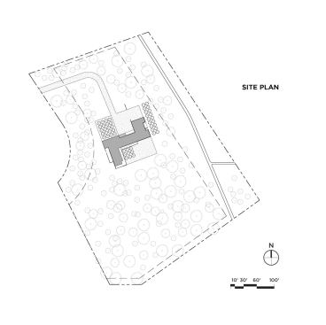 Site plan. The steel-clad residence sits on 8 acres of heavily wooded terrain.