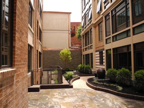 A courtyard with parking undernearth links the old townhouses with the building.
