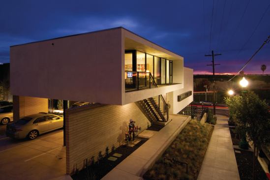 Stucco, glass, and metal join asphalt shingles as The Charmer's main exterior materials.