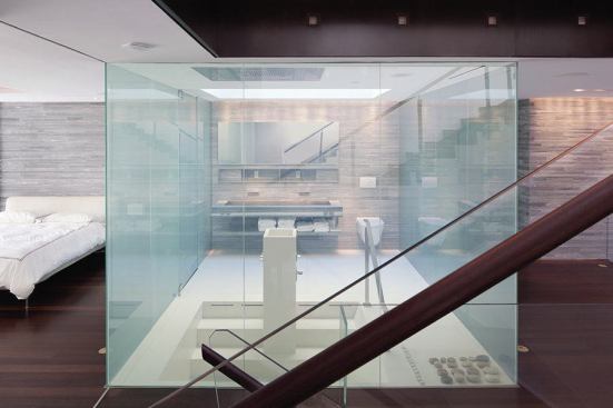 Boldly hi-tech in spirit, this glass-enclosed master bath has a trick up its sleeve.