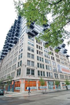 The project is an example of adaptive reuse with 11 stories of contemporary units built atop a seven story base built in the early 20th century.