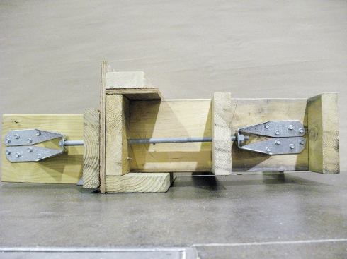 In this mock-up, the deck joists run perpendicular to the existing house joists,andl blocking is installed in the first two "joist bays." To find the correct location for the blocking in an actual job, the author drills a bolt hole from the exterior of the house, alongside the deck joist, then uses the hole’s location as a guide.