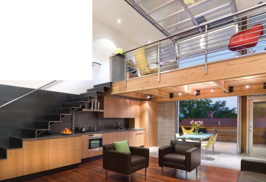 Changes in cabinet depth indicate a subtle shift from living space to kitchen.