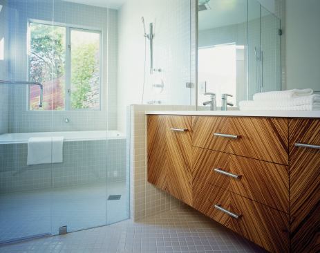 Bath cabinets are faced in a zebrawood veneer.