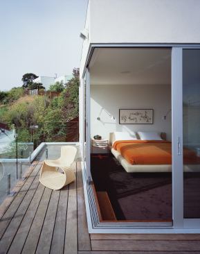 The top-floor master bedroom opens onto a rooftop deck.