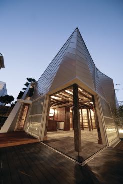 Corner sliding doors open onto a private terrace.