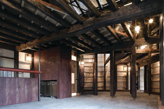 Two 100-year-old timber frames, relocated and combined, form the structural system of the new house.