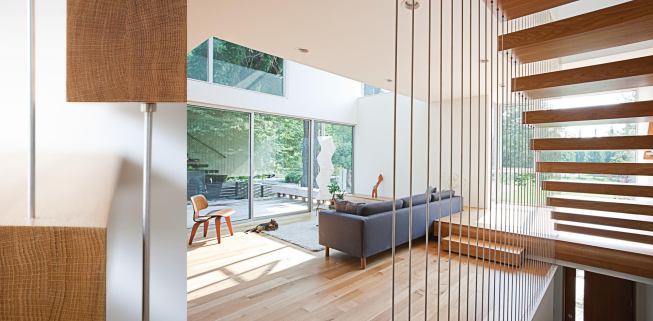 A tension rod-supported stair gives the effect of cantilevered treads, while also meeting code.


