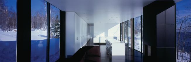 Kitchen appliances are either tucked out of view or designed to blend into the white interiors. "I wanted the kitchen to disappear," says Snow. "It keeps the house still."