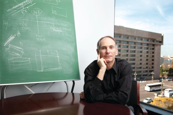 Eli Meir Kaplan/Wonderful Machine for EcoHome..Sam Rashkin poses for a portrait on Monday, November 14, 2011 in front of a chalkboard with technical information about energy efficiency and with his book, "Retooling the U.S. Housing Industry," in his office at the Department of Energy in Washington, DC.