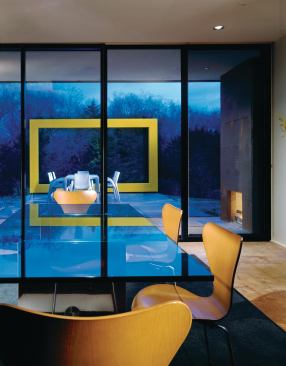 On the dining terrace, welded steel tubing is a vivid frame for the ever-changing eastern red cedars.