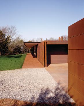 Reddish gravel mirrors the house's roof overhang.