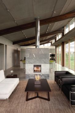 A heated concrete slab keeps the interiors toasty all year round, and it works well as thermal mass for passive solar. Cross-ventilation throughout the house allows for natural cooling during the warmer months. 
