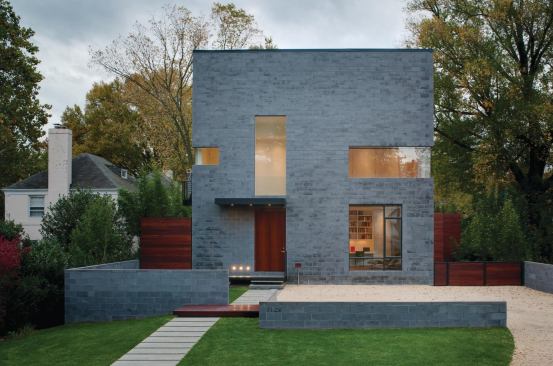 Mahogany and concrete block landscape walls complement the cube and orchestrate the relationship between the street, a required parking court, and the house.

