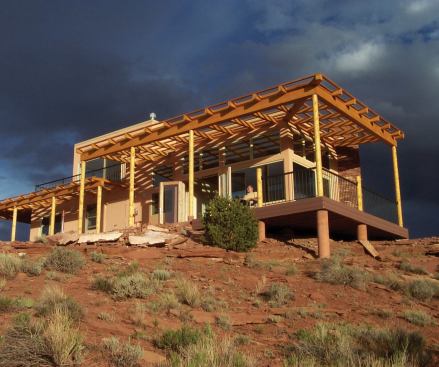 A large, sheltered porch provides shade and extends the interior living space.