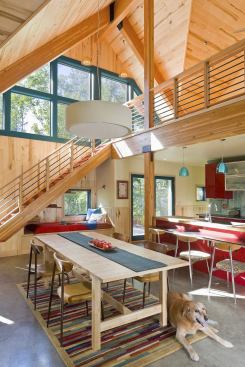 The double-height, sunny great room includes a dining area and a second floor that's open to the rest of the house. 