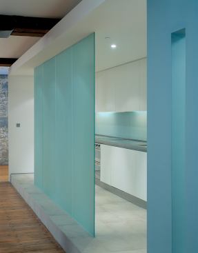 Fixed translucent-glass panels define the kitchen’s

edges while allowing light to filter through.